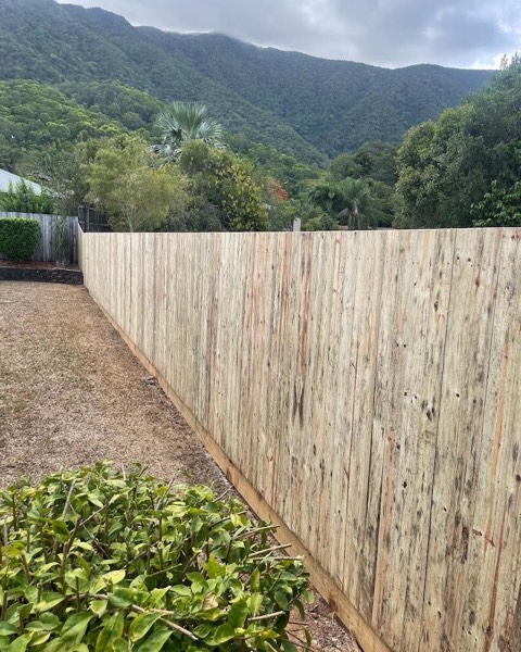 A new timber paling fence beside a garden bed